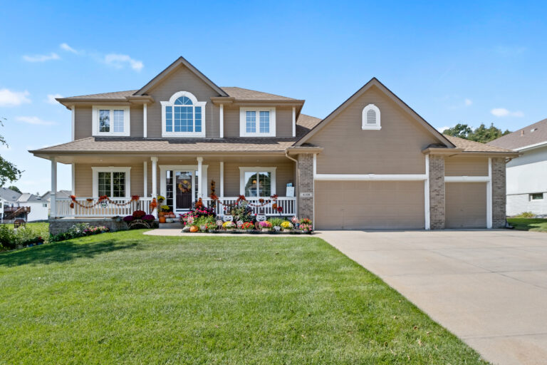 Brown two story house with fall decorations