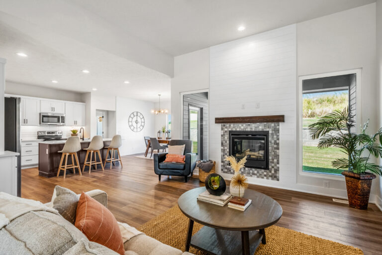 White living and dining room with gold and yellow accents in furniture.