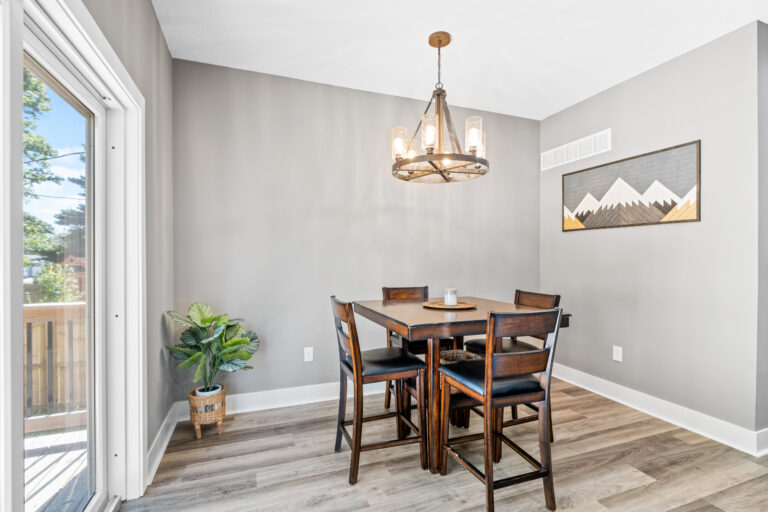 Grey dining room and deck door with natural lighting